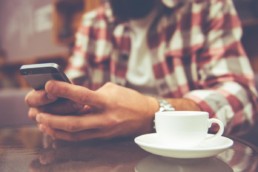 Let's shape the future of loyalty programs - a man in a cafe on his phone